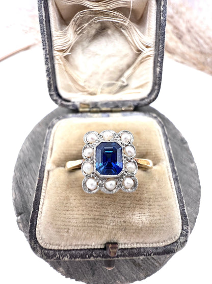A sapphire and pearl cluster ring in yellow gold and platinum, in an antique ring box