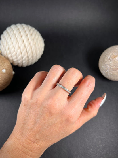 A full eternity ring in white gold, set with diamonds, modelled on a hand