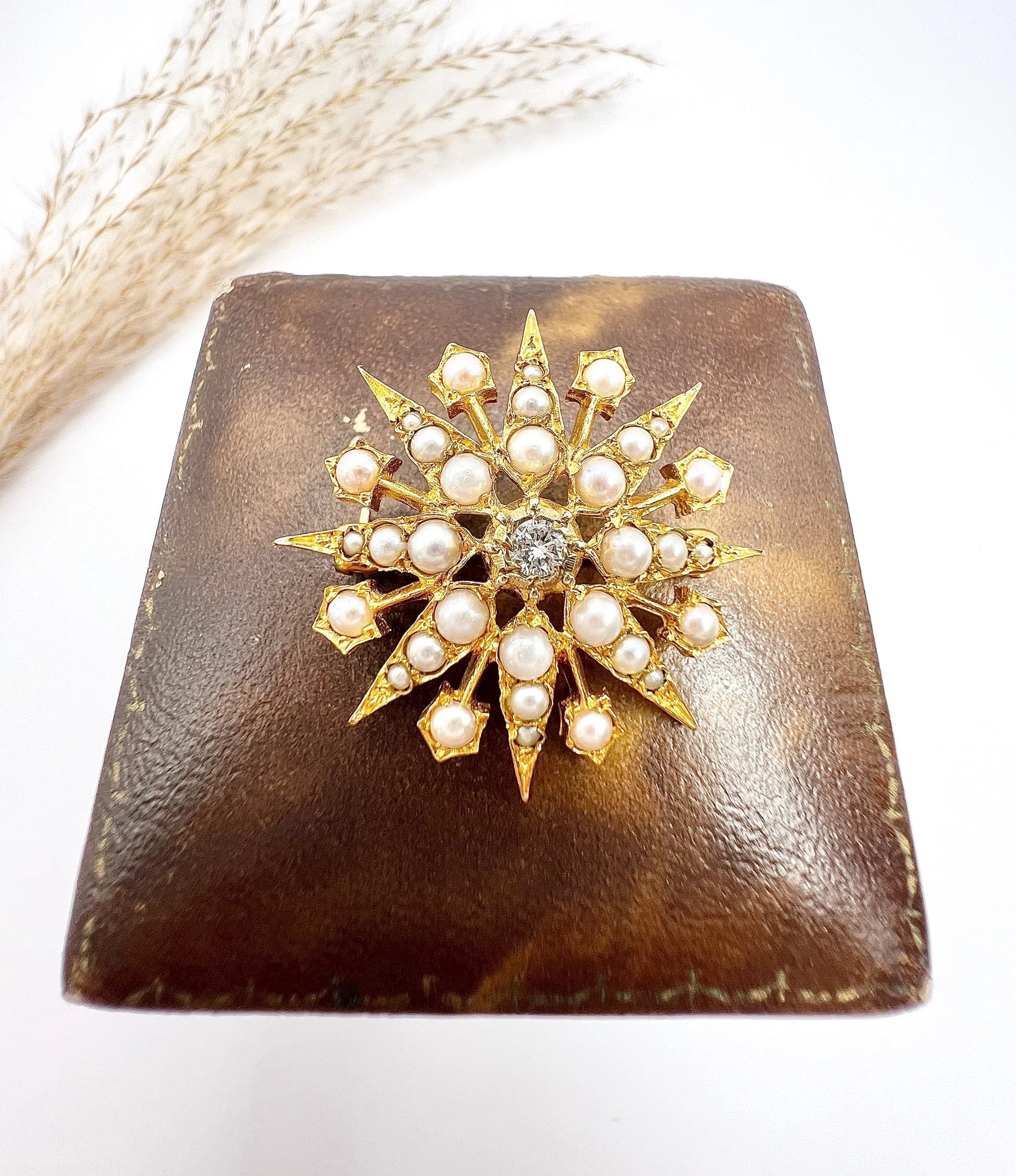 A star-shaped pearl and diamond brooch/pendant in yellow gold