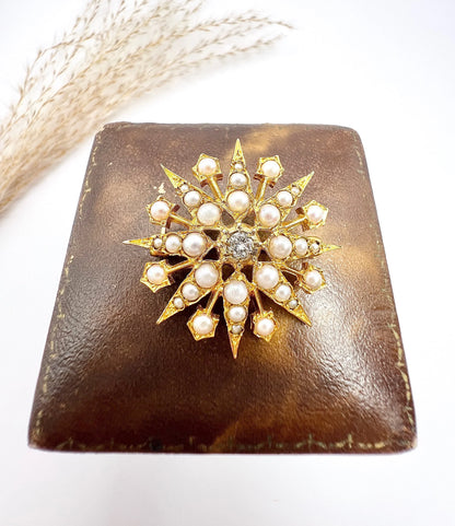 A star-shaped pearl and diamond brooch/pendant in yellow gold
