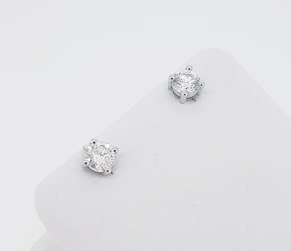 0.91ct Diamond Stud Earrings; round brilliant-cut diamonds, four-claw set, in 18ct white gold. Total diamond weight: 0.91 carats.
