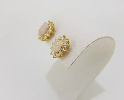 Opal and Diamond Oval Cluster Stud Earrings; 2.34cts oval cabochon opals surrounded by 1.06cts brilliant-cut diamonds, in 18ct yellow gold