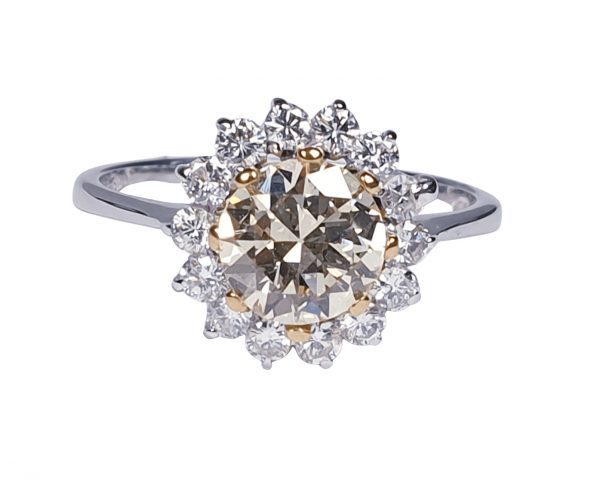 Old Cut Fancy Yellow Diamond Cluster Ring; featuring a 1.28 carat old European transitional cut fancy yellow diamond surrounded by a halo of sparkling white diamonds. Mounted in platinum