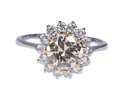 Old Cut Fancy Yellow Diamond Cluster Ring; featuring a 1.28 carat old European transitional cut fancy yellow diamond surrounded by a halo of sparkling white diamonds. Mounted in platinum