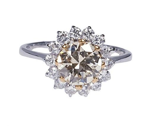 Old Cut Fancy Yellow Diamond Cluster Ring; featuring a 1.28 carat old European transitional cut fancy yellow diamond surrounded by a halo of sparkling white diamonds. Mounted in platinum