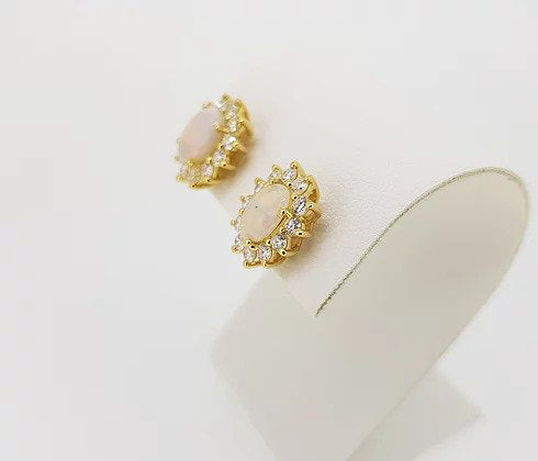 Opal and Diamond Oval Cluster Stud Earrings; 2.34cts oval cabochon opals surrounded by 1.06cts brilliant-cut diamonds, in 18ct yellow gold