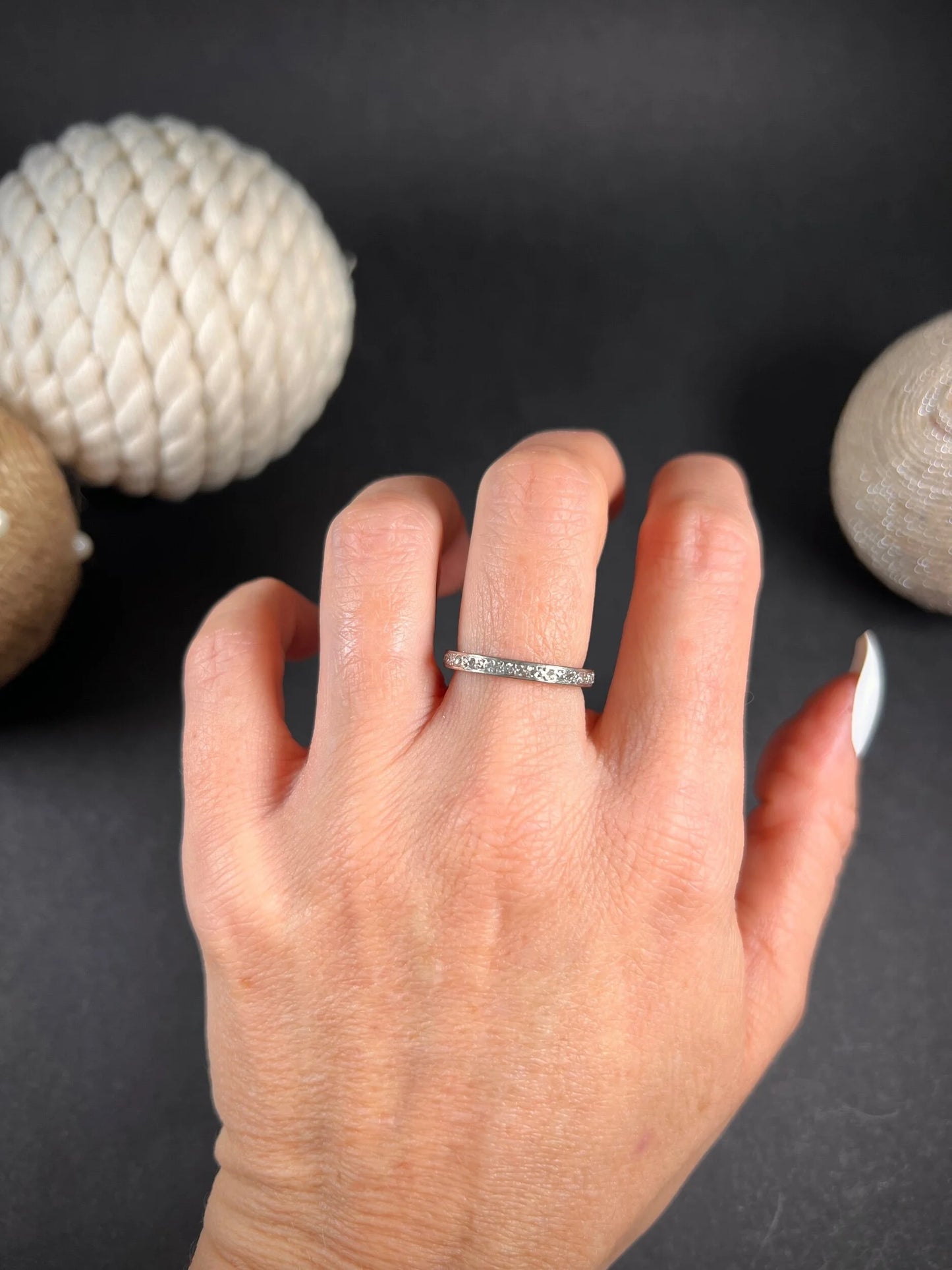 A full eternity ring in white gold, set with diamonds, modelled on a hand