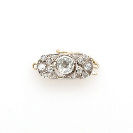 Antique Edwardian Diamond Brooch in Platinum and 15ct Gold; An early 20th Century platinum and 15ct gold clasp set with diamonds totalling 0.25 carats.