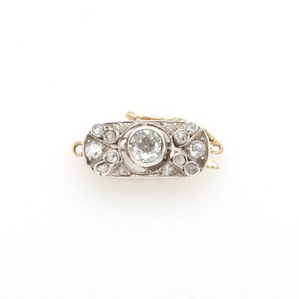 Antique Edwardian Diamond Brooch in Platinum and 15ct Gold; An early 20th Century platinum and 15ct gold clasp set with diamonds totalling 0.25 carats.
