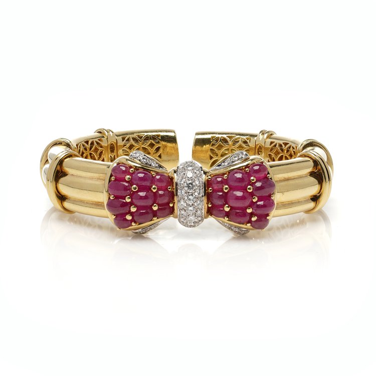 Italian 18ct Yellow Gold Bangle with Burma Ruby and Diamond Bow; set with 8.40 carats cabochon natural Burma rubies and 1.21 carats brilliant-cut diamonds. Circa 1990s