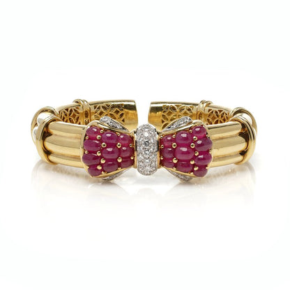 Italian 18ct Yellow Gold Bangle with Burma Ruby and Diamond Bow; set with 8.40 carats cabochon natural Burma rubies and 1.21 carats brilliant-cut diamonds. Circa 1990s