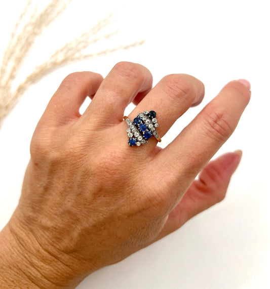 A navette shaped sapphire and diamond ring in yellow gold, modelled on a hand