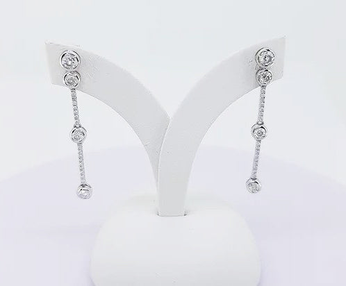 Contemporary Diamond Drops Earrings; featuring bezel set brilliant-cut diamonds linked via smaller diamond set links, 0.70 carat total, 18ct white gold.