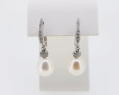 Pearl and Diamond Drop Earrings; featuring pearls suspended from diamond set hoops via diamond clusters. Mounted in 18ct white gold.