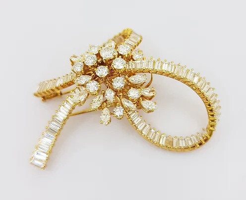 Vintage Multi Cut Diamond Bow Brooch; set with brilliant-cut, marquise-cut and baguette-cut diamonds, 9.00 carat total, mounted in 18ct yellow gold.