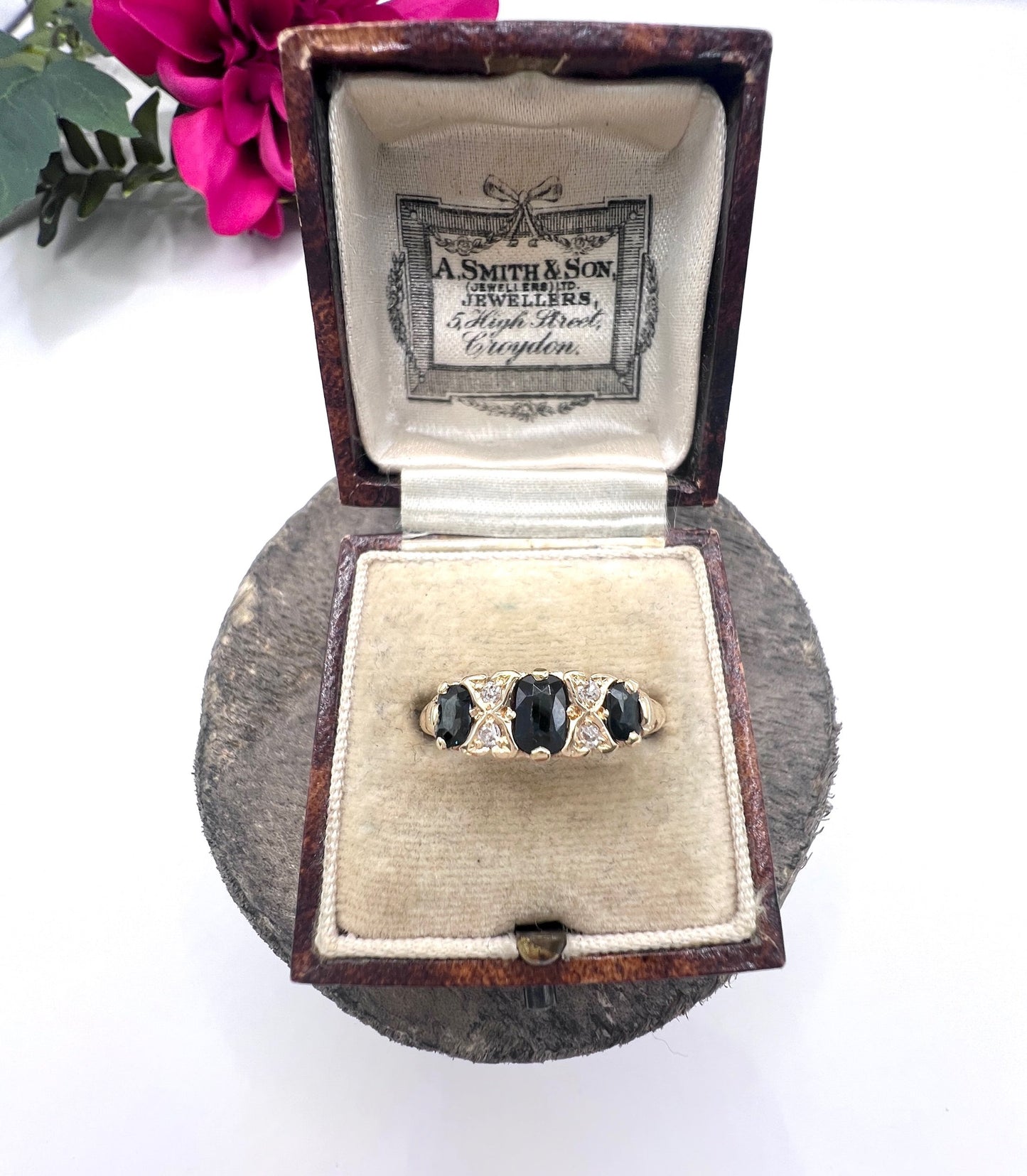 A seven stone sapphire and diamond carved ring in yellow gold, in a ring box