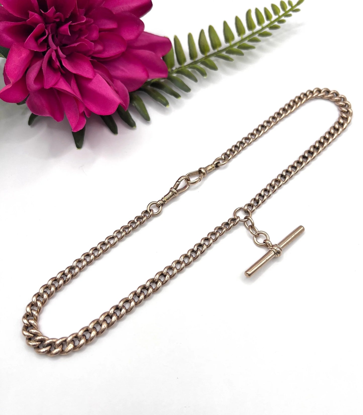 A rose gold curb link Albert chain with t-bar