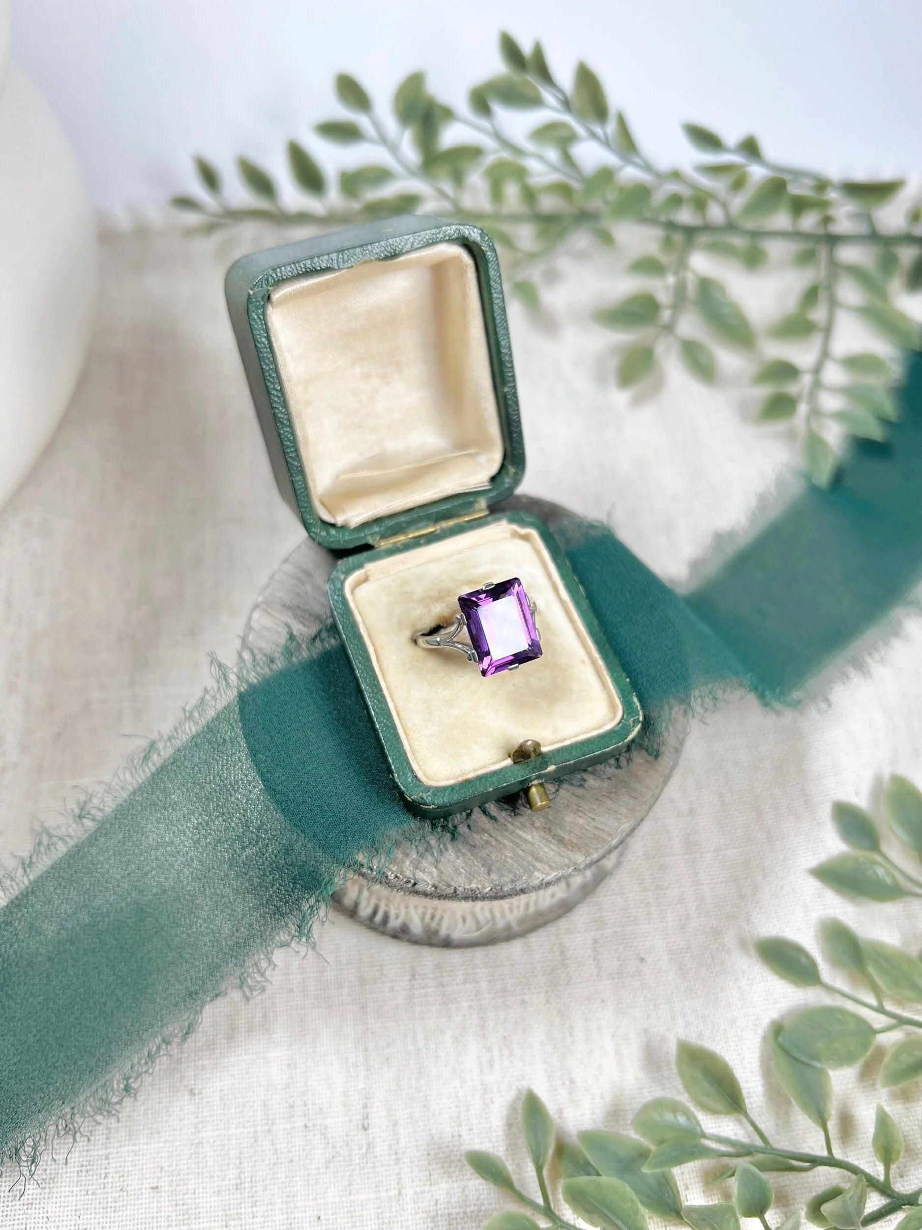 A solitaire amethyst cocktail ring in platinum, in a box