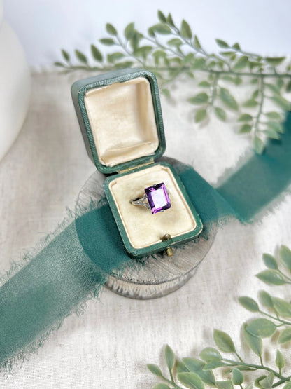 A solitaire amethyst cocktail ring in platinum, in a box