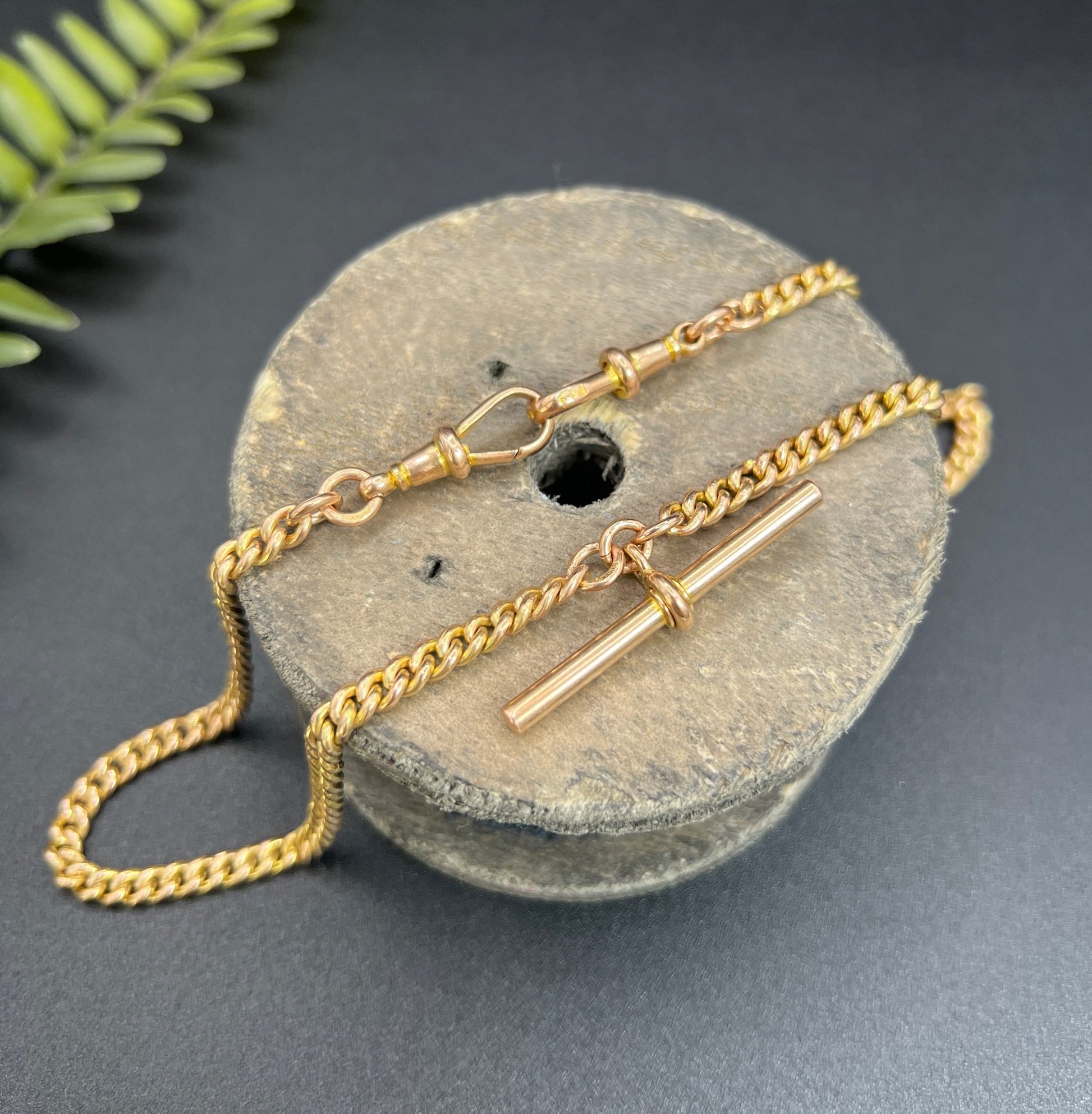 A yellow gold curb link Albert watch chain