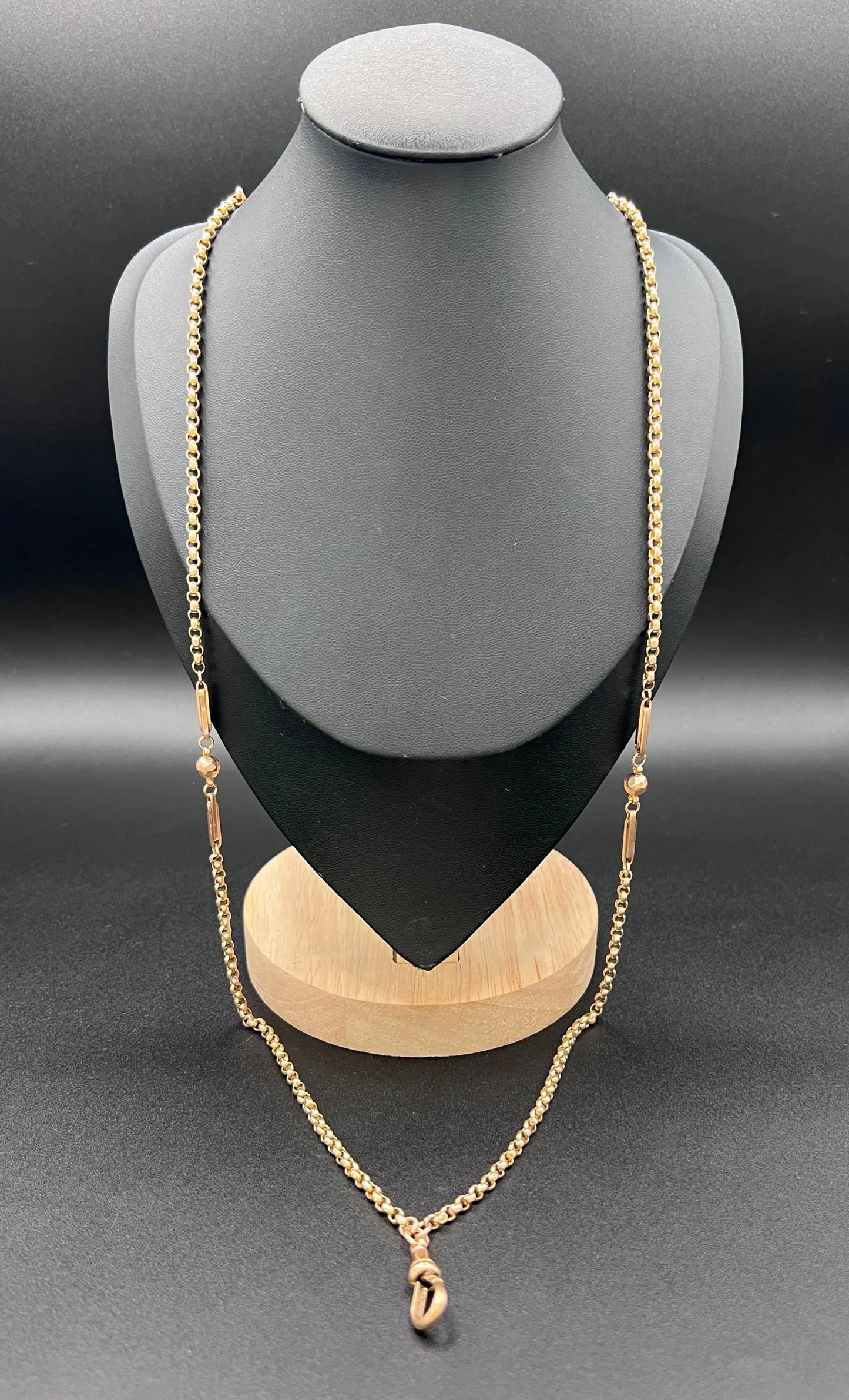 A long rose gold chain necklace with a dog clip clasp