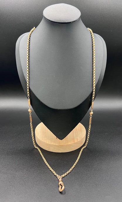 A long rose gold chain necklace with a dog clip clasp