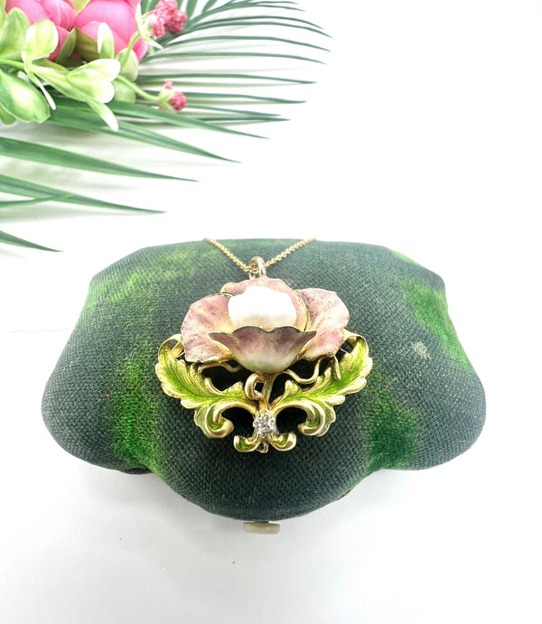 An enamel, diamond and pearl flower pendant with a gold chain