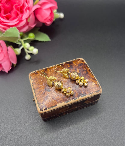 A pair of yellow gold leaf and faceted ball drop earrings with hook fittings