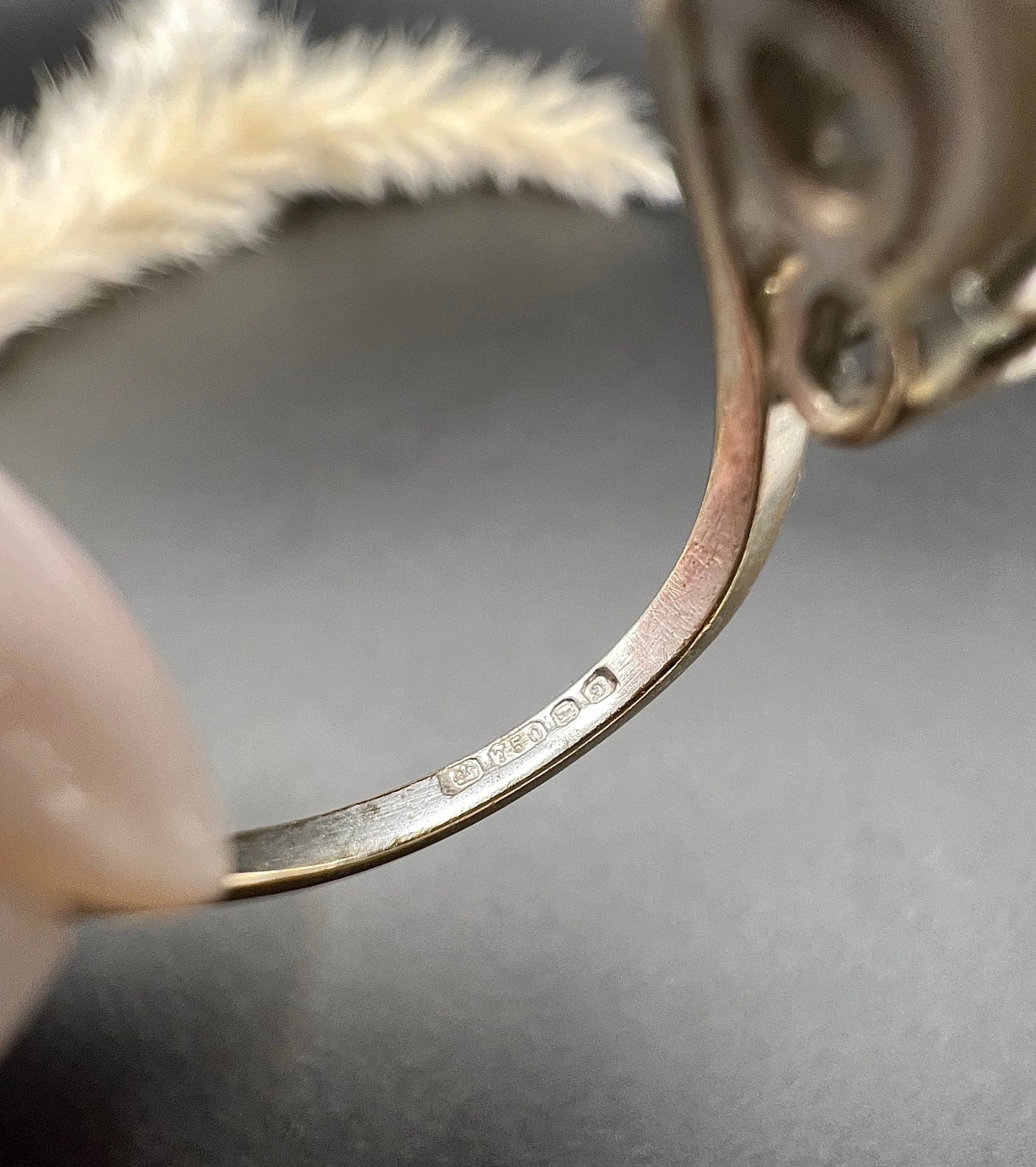 A close-up of a hallmark inside a ring shank