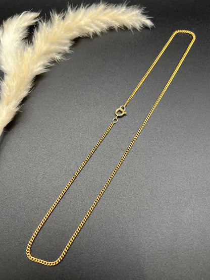 A fine curb link chain necklace in yellow gold