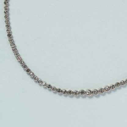 9ct Diamond Line Tennis Necklace in Platinum, 9 carats of round brilliant-cut diamonds set in individual bezel settings which gradually increase in size to the middle