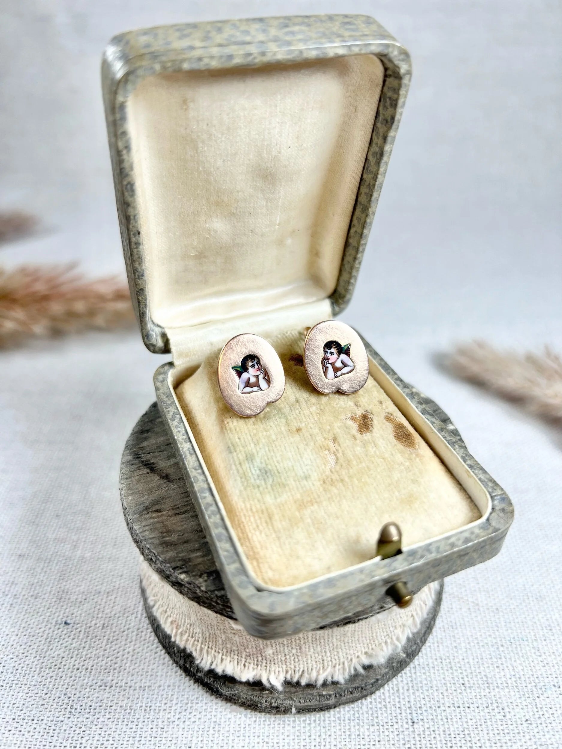 A pair of art palette shaped gold earrings with enamelled cherubs, in a box