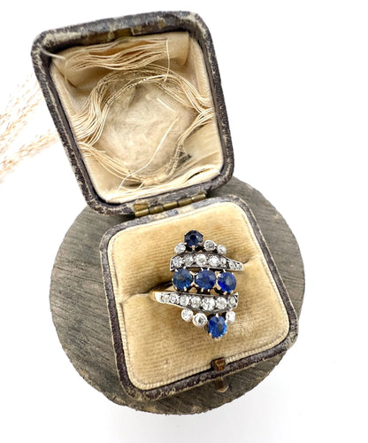 A navette shaped sapphire and diamond ring in yellow gold, in an antique ring box