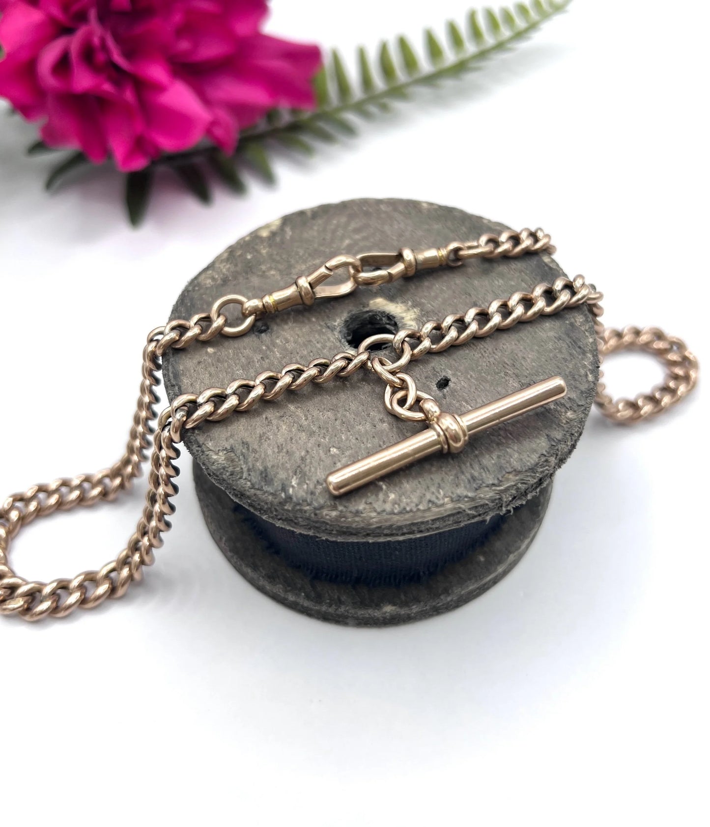A rose gold curb link Albert chain with t-bar