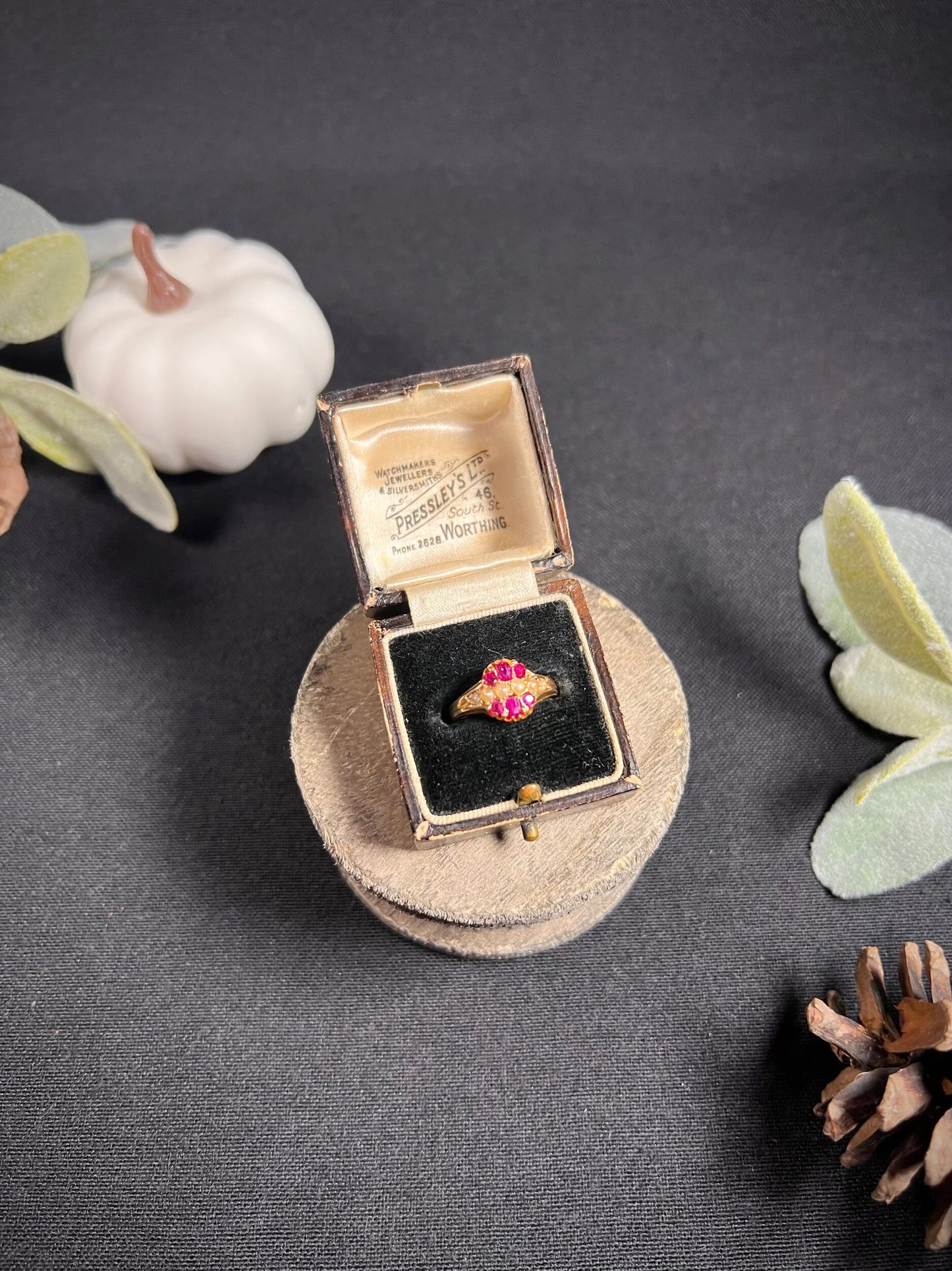 A yellow gold ruby and pearl cluster ring, in a ring box