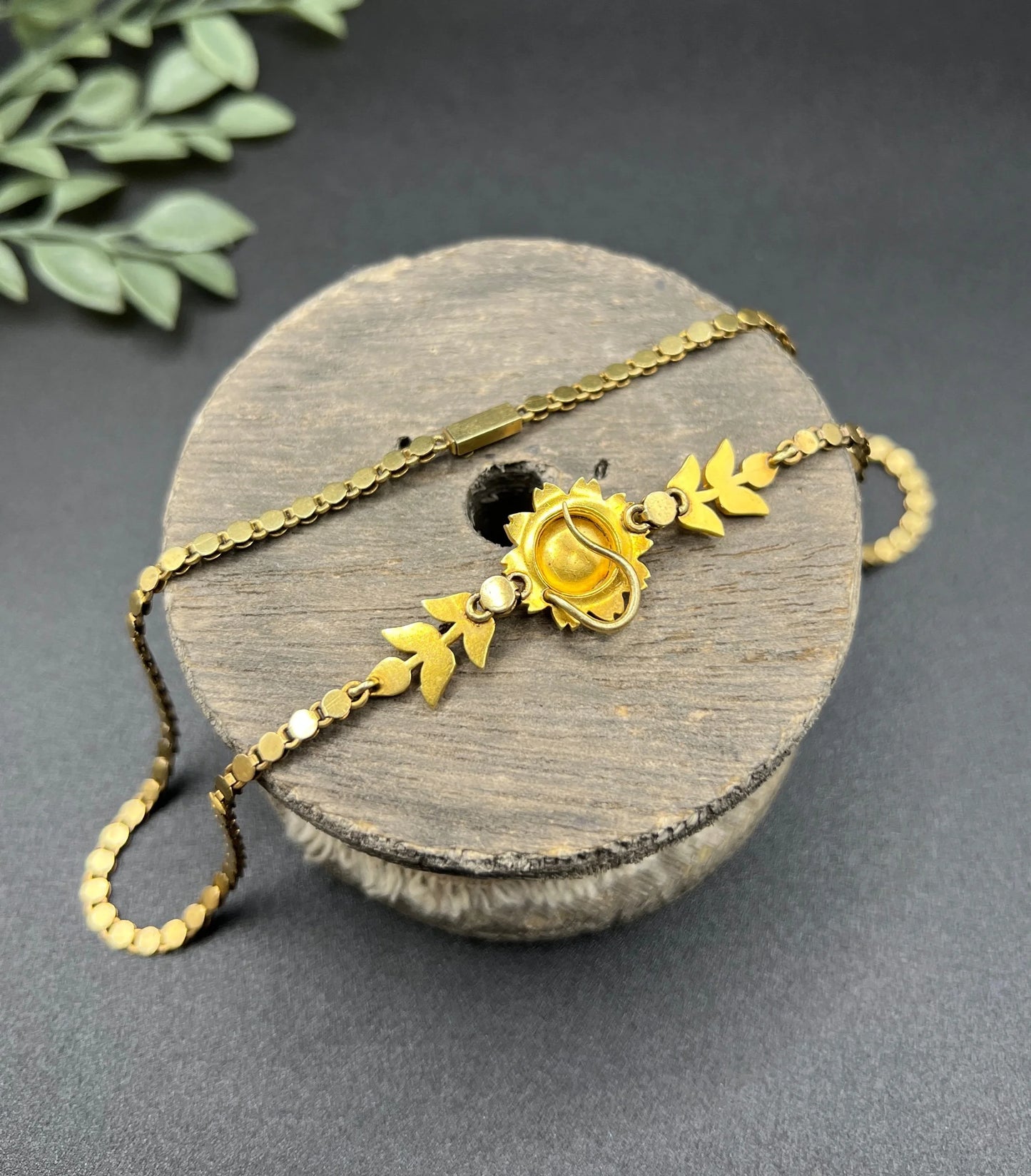 A yellow gold pearl floral necklace with integrated chain