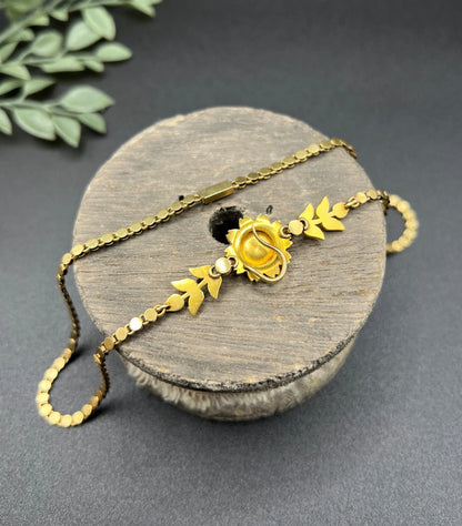 A yellow gold pearl floral necklace with integrated chain