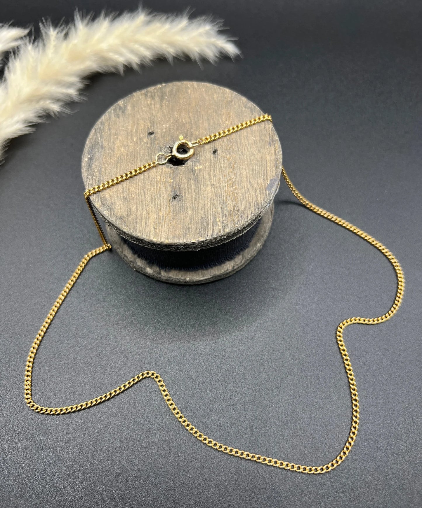 A fine curb link chain necklace in yellow gold