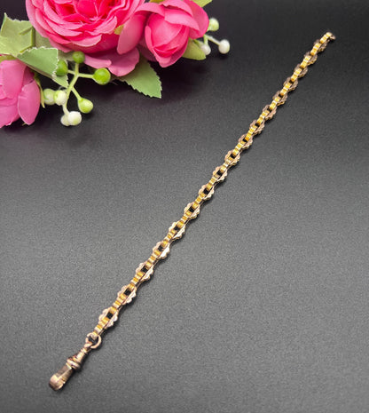 A fancy link yellow gold bracelet with a lobster claw clasp