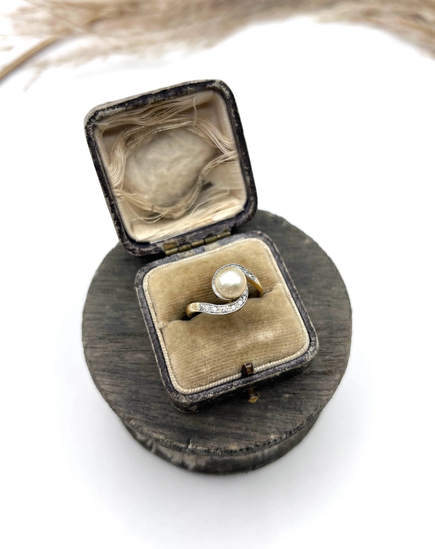 A pearl and diamond crossover swirl ring in yellow and white gold, in an antique ring box