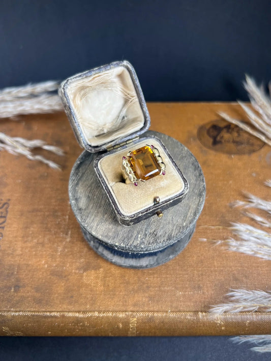 An emerald cut citrine and cabochon ruby yellow gold cocktail ring, in an antique ring box