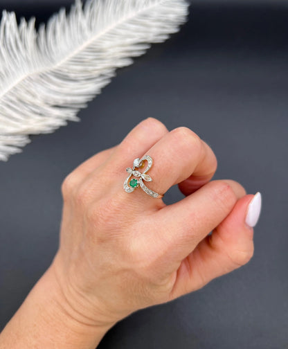 An emerald and diamond fancy openwork ring in yellow gold and platinum, modelled on a hand