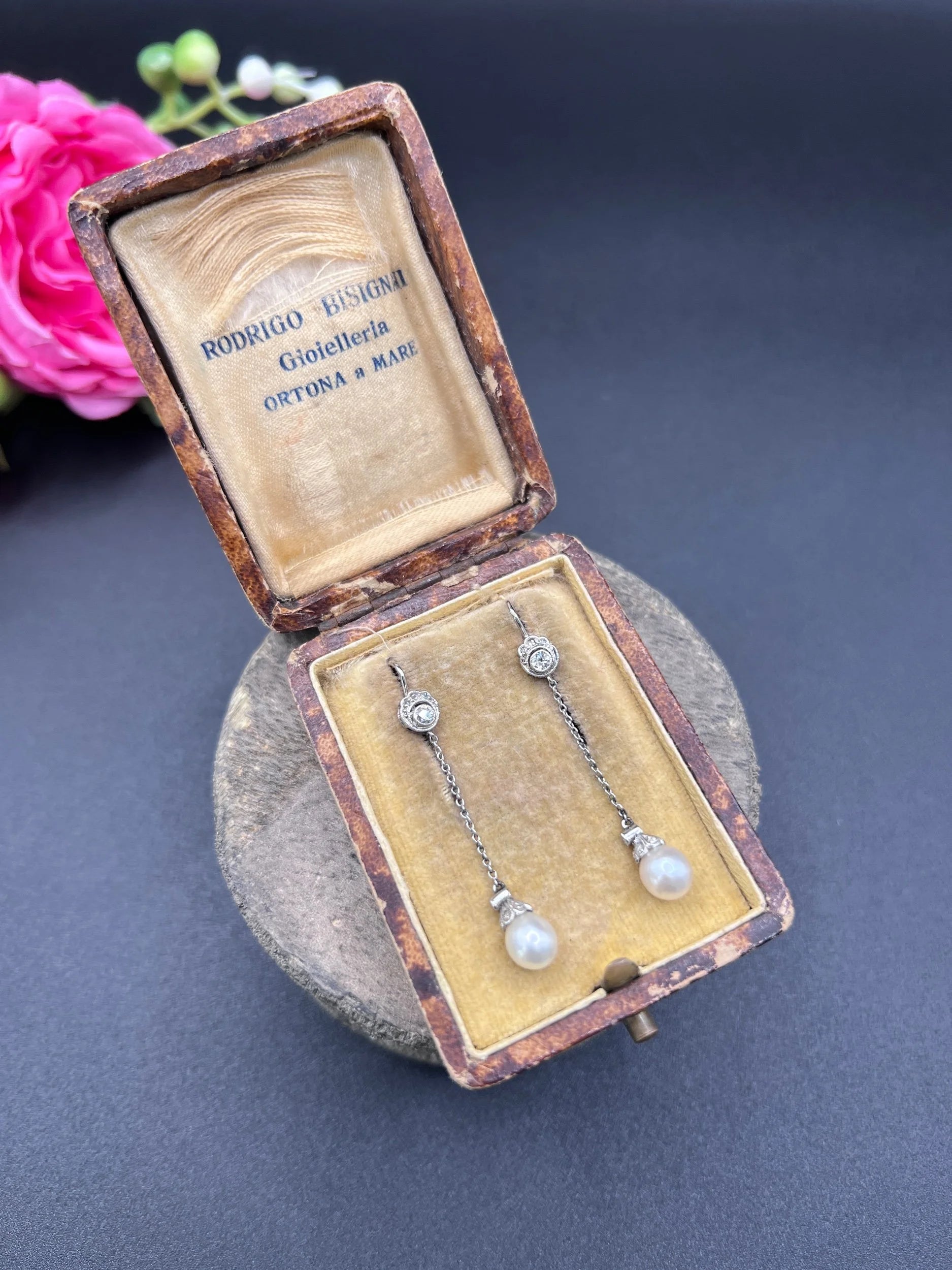 A pair of long drop platinum earrings with pearls and diamonds, in an antique box