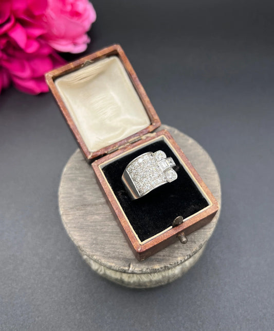 A round diamond tank style cocktail ring in platinum, in a ring box