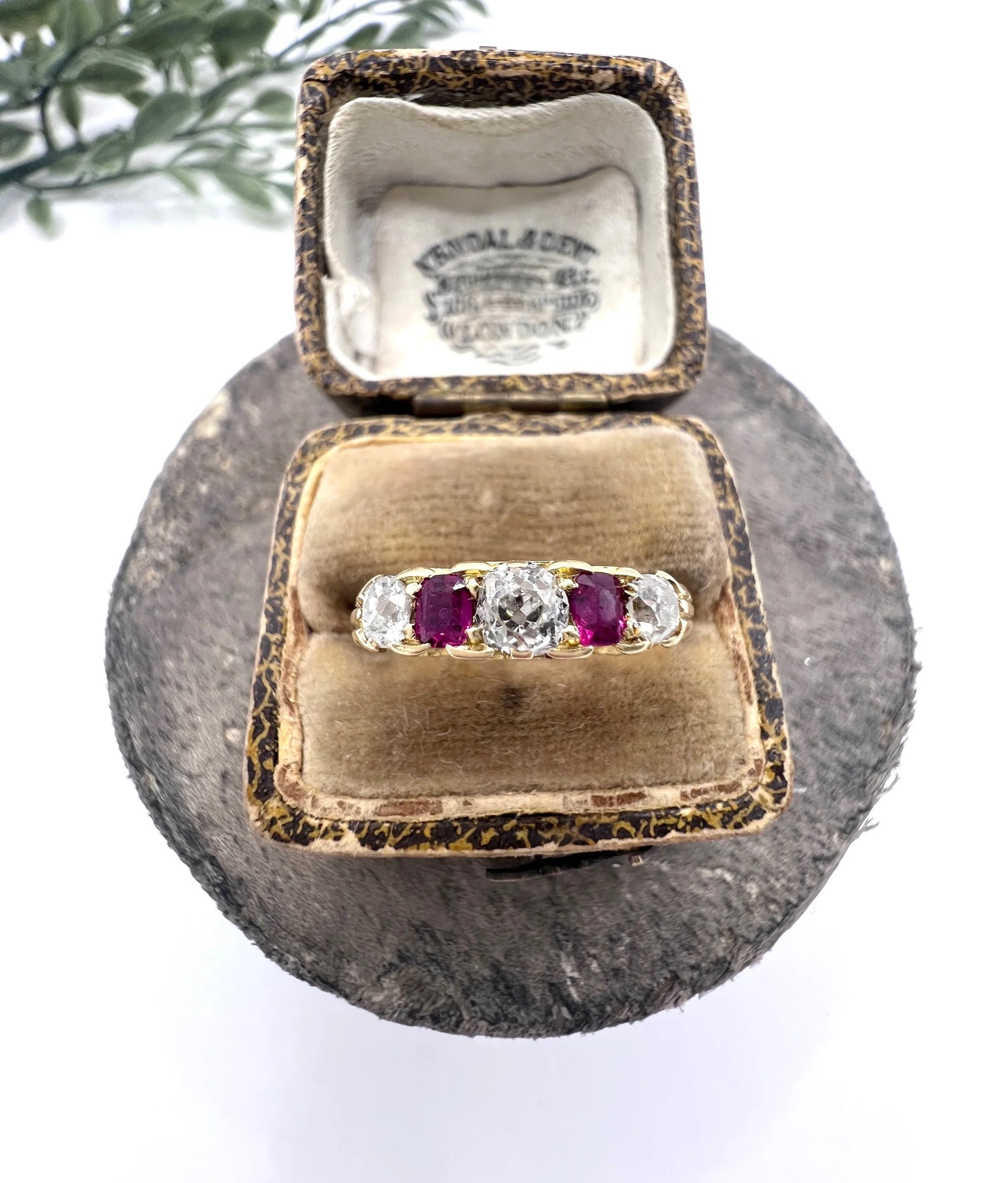 A yellow gold ruby and diamond five stone ring, in a ring box