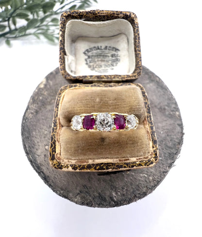 A yellow gold ruby and diamond five stone ring, in a ring box