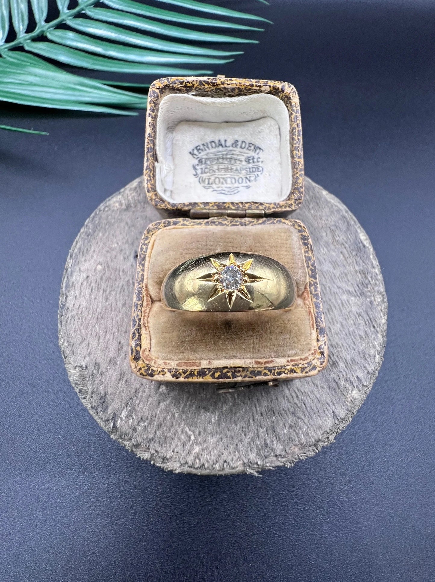 A single stone old cut diamond gypsy band ring in yellow gold, in an antique ring box