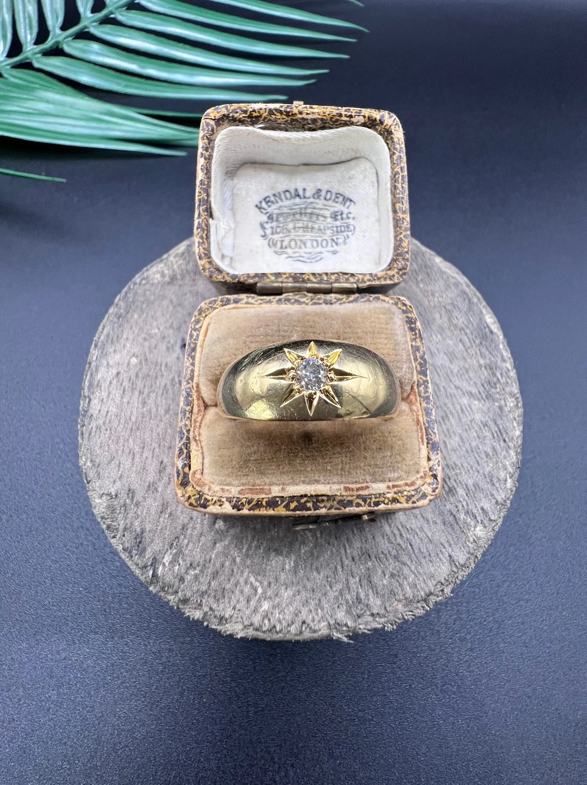 A single stone old cut diamond gypsy band ring in yellow gold, in an antique ring box
