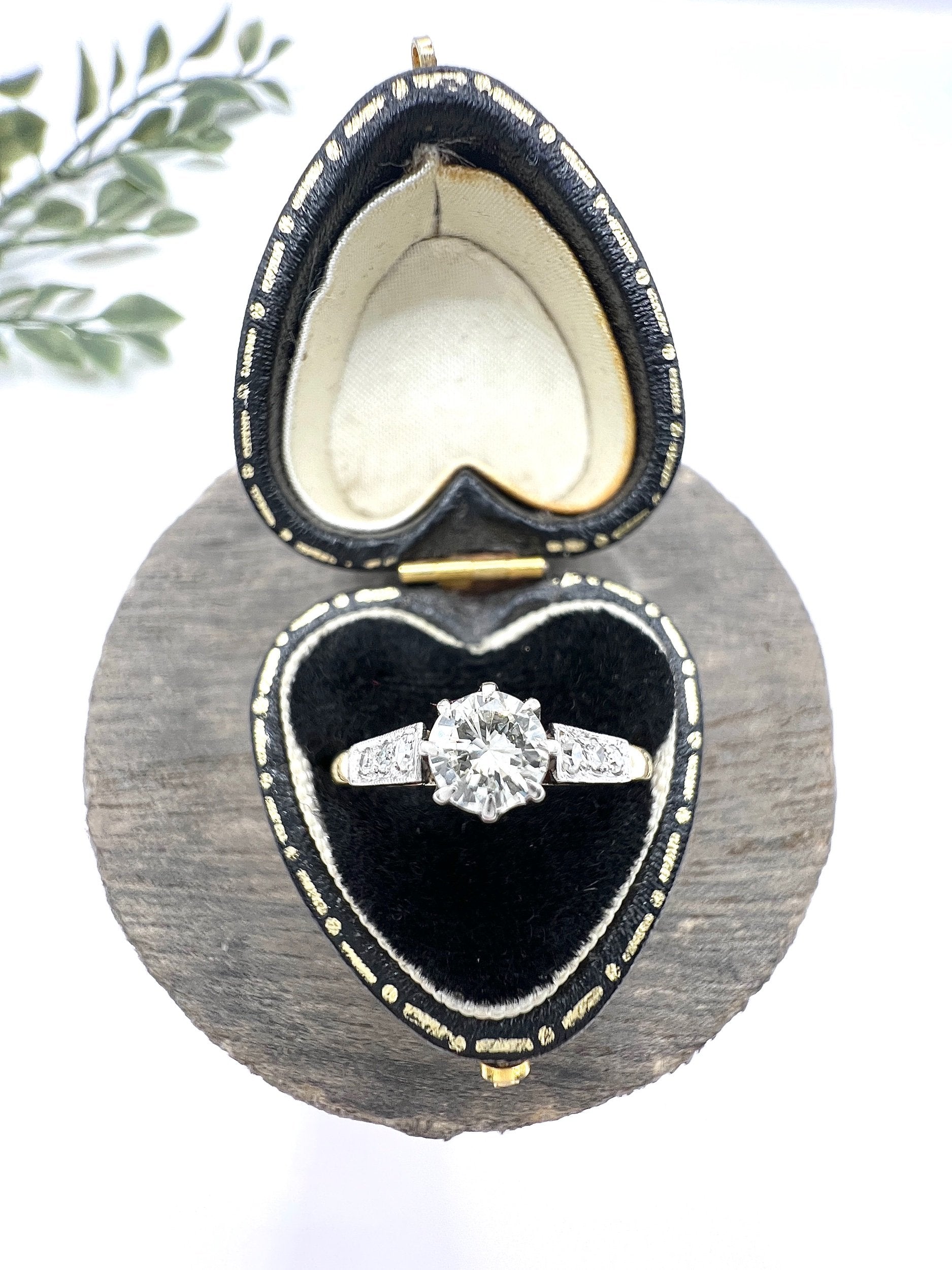 A diamond engagement style ring in yellow gold and platinum, in a ring box