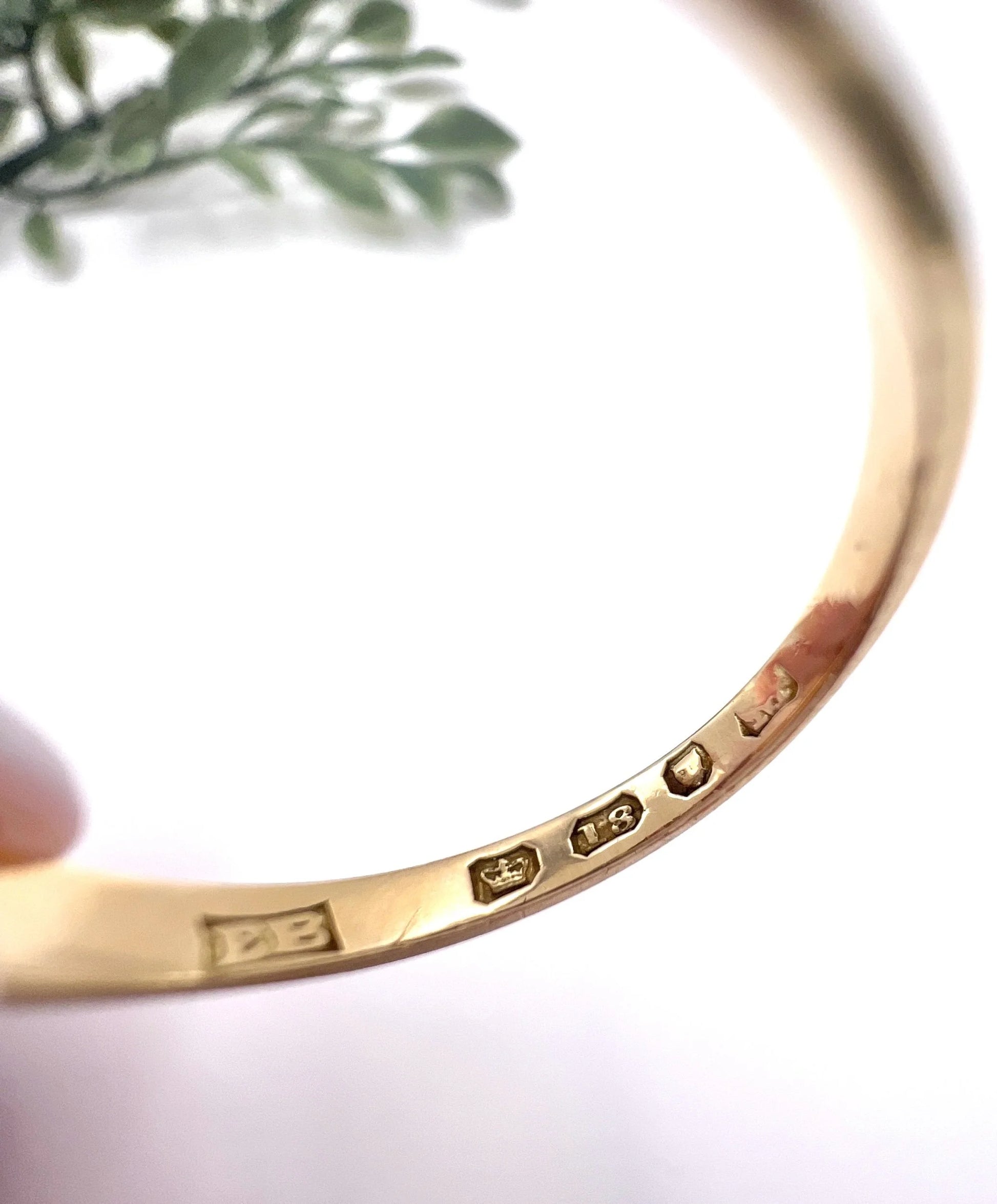 Close-up of an 18 carat gold hallmark inside a yellow gold ring shank